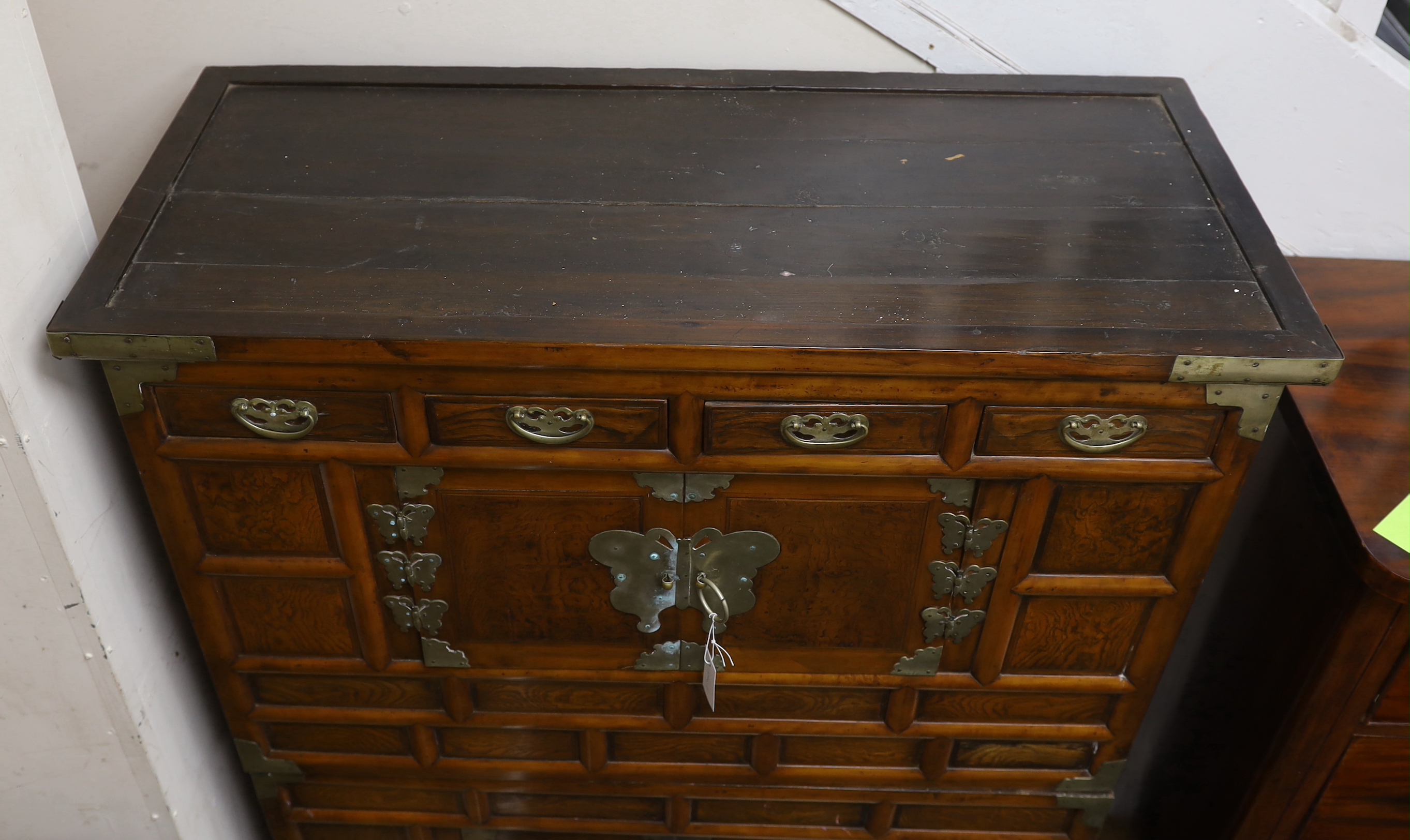 A Korean gilt metal mounted elm two part side cabinet, width 108cm, depth 46cm, height 149cm